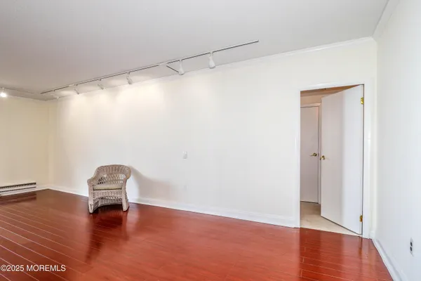 a view of a room with wooden floor