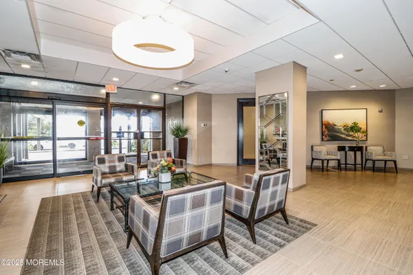 a living room with fireplace furniture and a table