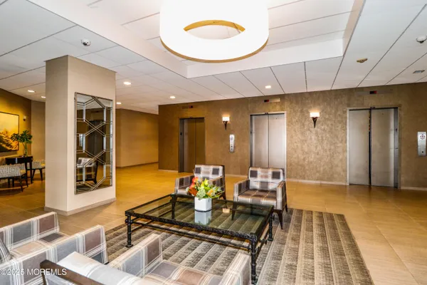 a lobby with furniture and view of a bathroom