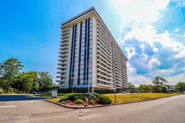 a view of a tall building next to a road