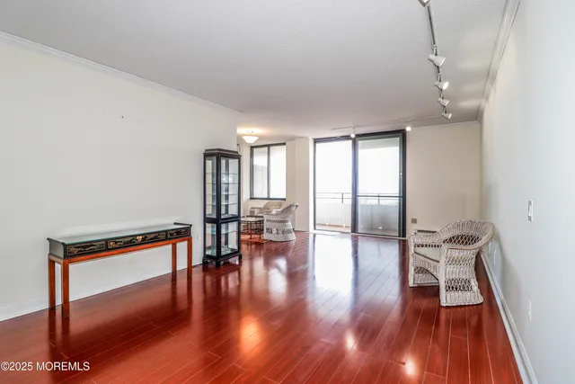 a view of a room with wooden floor and furniture