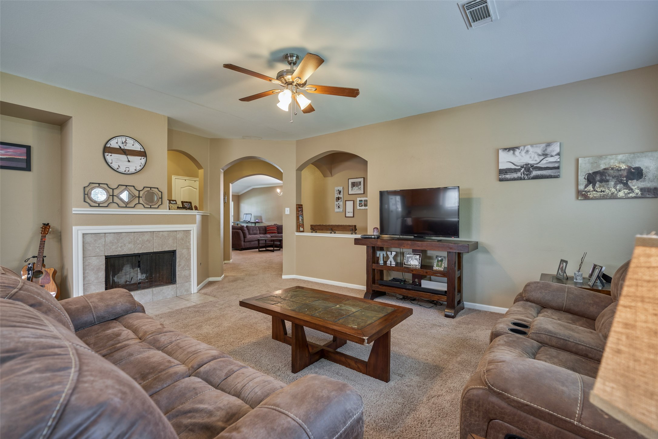 6214 Channelbrook Lane Spring, TX 77379 - Photo 11 of 29 a living room with furniture a flat screen tv and a fireplace