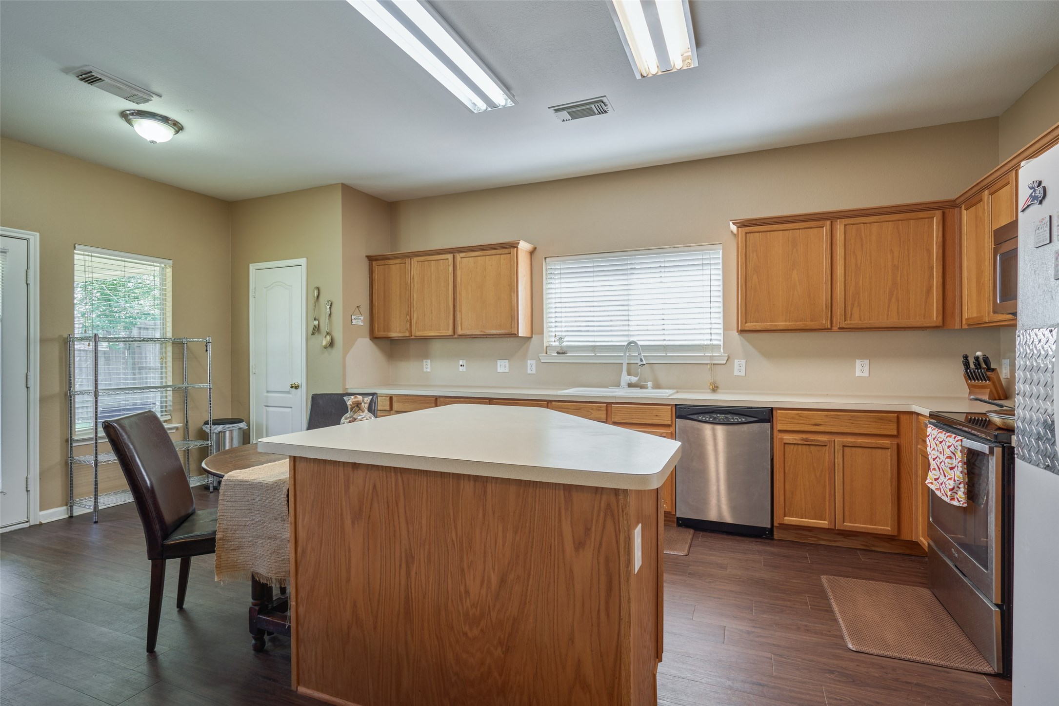 6214 Channelbrook Lane Spring, TX 77379 - Photo 13 of 29 a kitchen with stainless steel appliances granite countertop sink stove top oven and cabinets