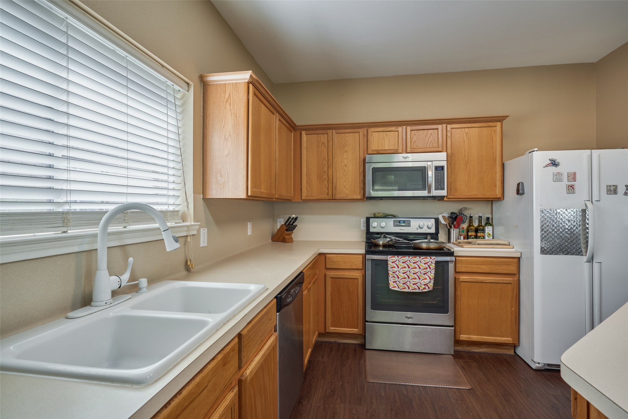 6214 Channelbrook Lane Spring, TX 77379 - Photo 16 of 29 a kitchen with stainless steel appliances granite countertop a sink stove and refrigerator
