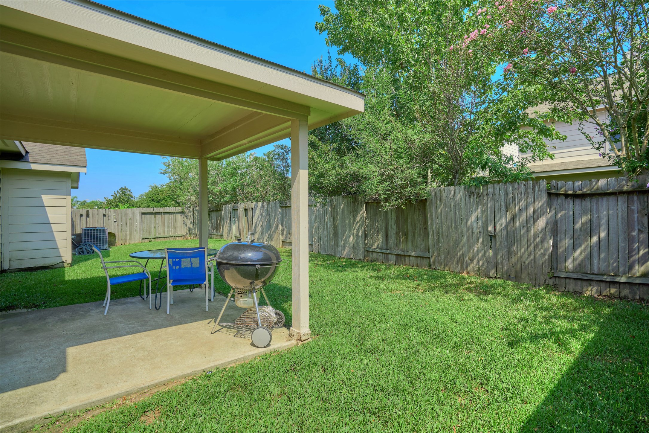 6214 Channelbrook Lane Spring, TX 77379 - Photo 27 of 29 a view of a chair and table in backyard of the house