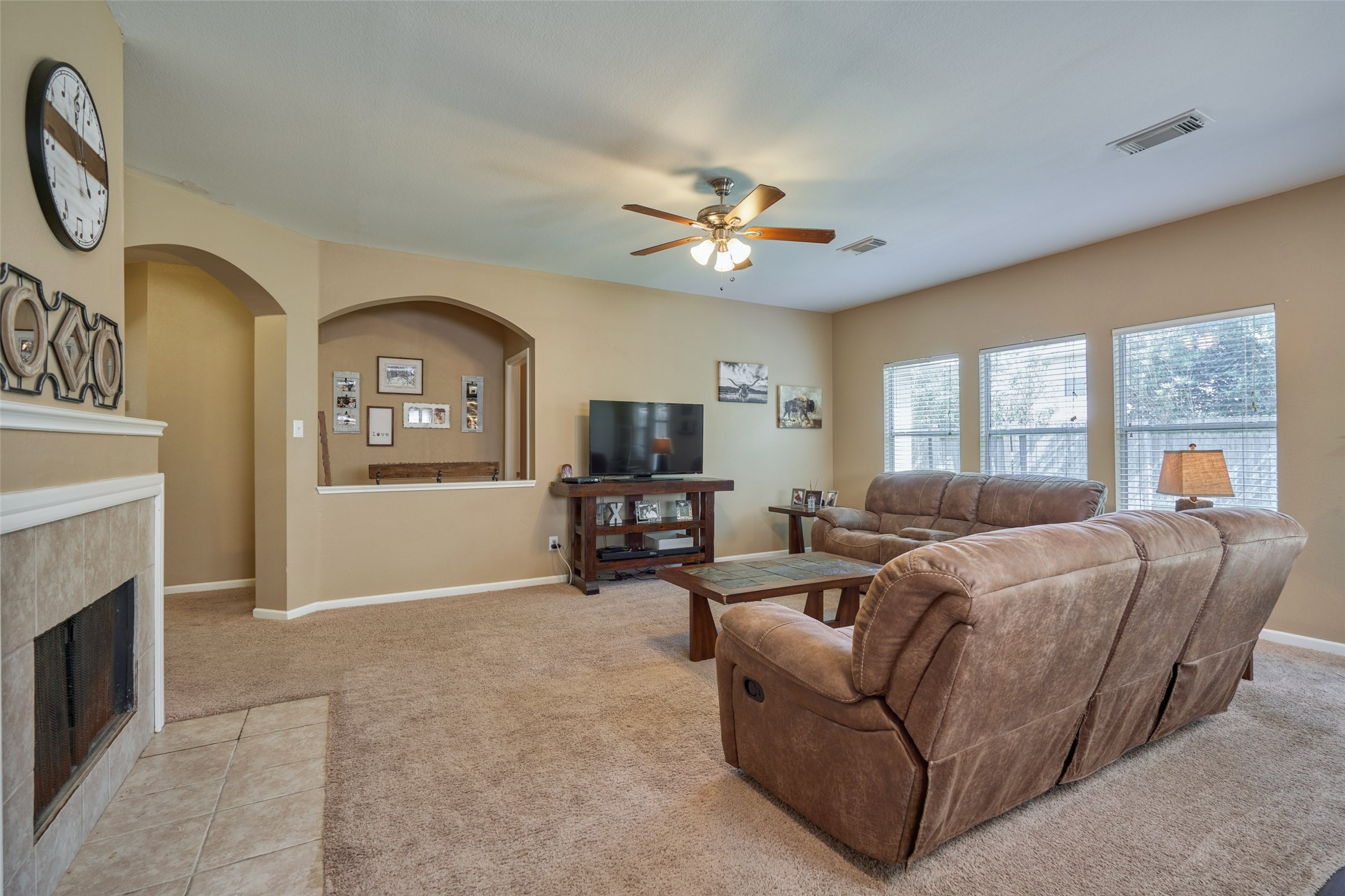 6214 Channelbrook Lane Spring, TX 77379 - Photo 10 of 29 a living room with furniture a fireplace and a flat screen tv
