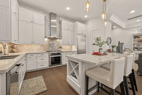 a kitchen with kitchen island granite countertop lots of counter top space and stainless steel appliances