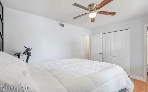 a bedroom with a bed and a ceiling fan