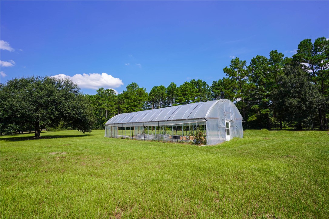 2092 Farm To Market 1486 Anderson, TX 77830 - Photo 23 of 42 a view of a garden with a house in the background