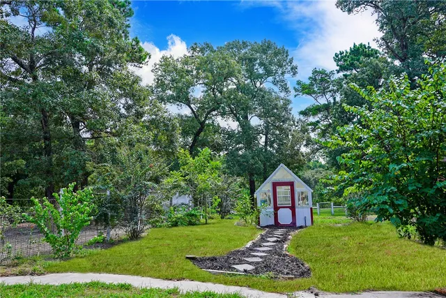 a front view of a house with a yard and trees