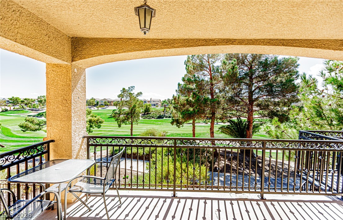 75 Tall Ruff Drive Las Vegas, NV 89148 - Photo 45 of 64 An elevated covered balcony overlooks the manicured fairways of a neighboring golf course.