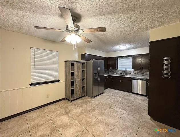 a large kitchen with a stove and a refrigerator