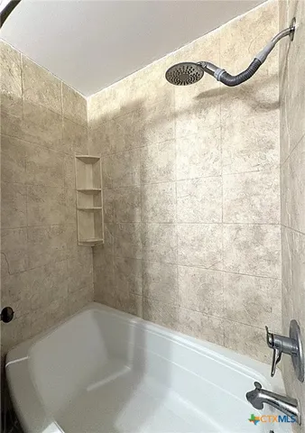 a bathroom with a bathtub and a shower