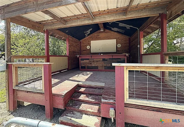 a view of a porch with furniture and wooden floor