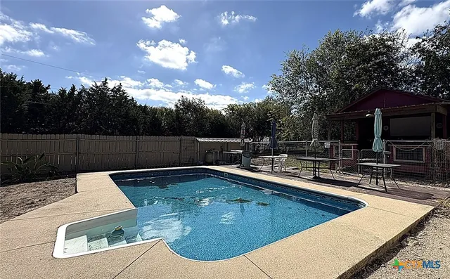 a view of a swimming pool with a patio