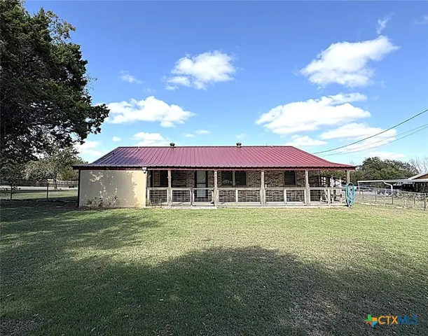 a front view of a house with a garden and yard
