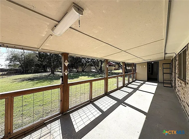 a yellow house with trees in front of it