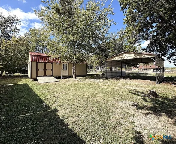 a wooden bench sitting in front of a house
