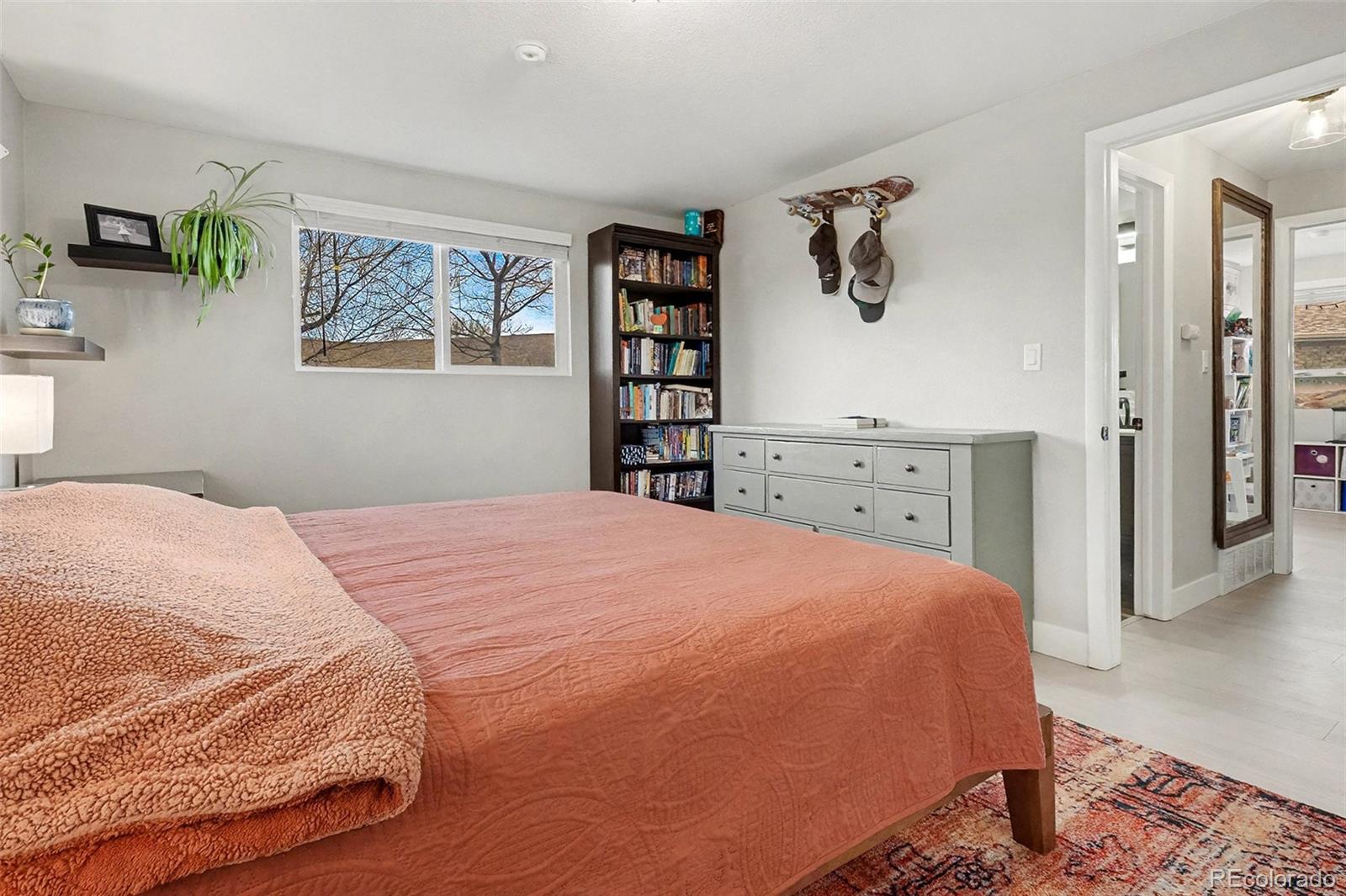 4784 Swadley Street Wheat Ridge, CO 80033 - Photo 14 of 22 a bedroom with a bed and a cabinets