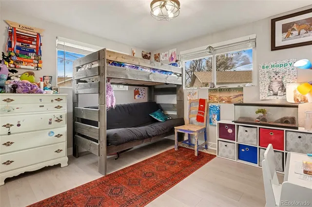 a bedroom with furniture and a baby crib