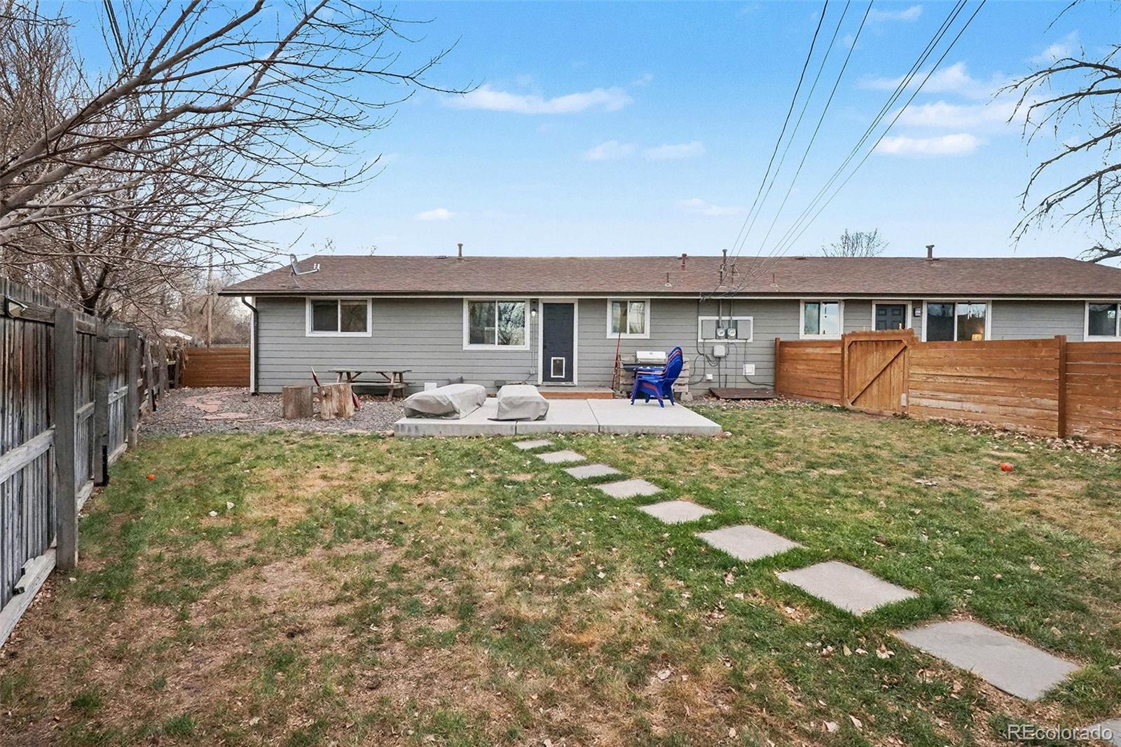 4784 Swadley Street Wheat Ridge, CO 80033 - Photo 18 of 22 a front view of house with yard and seating area