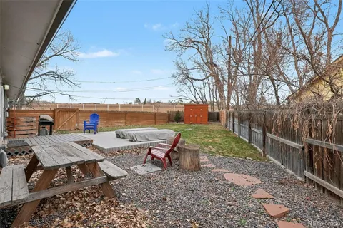 a backyard of a house with table and chairs