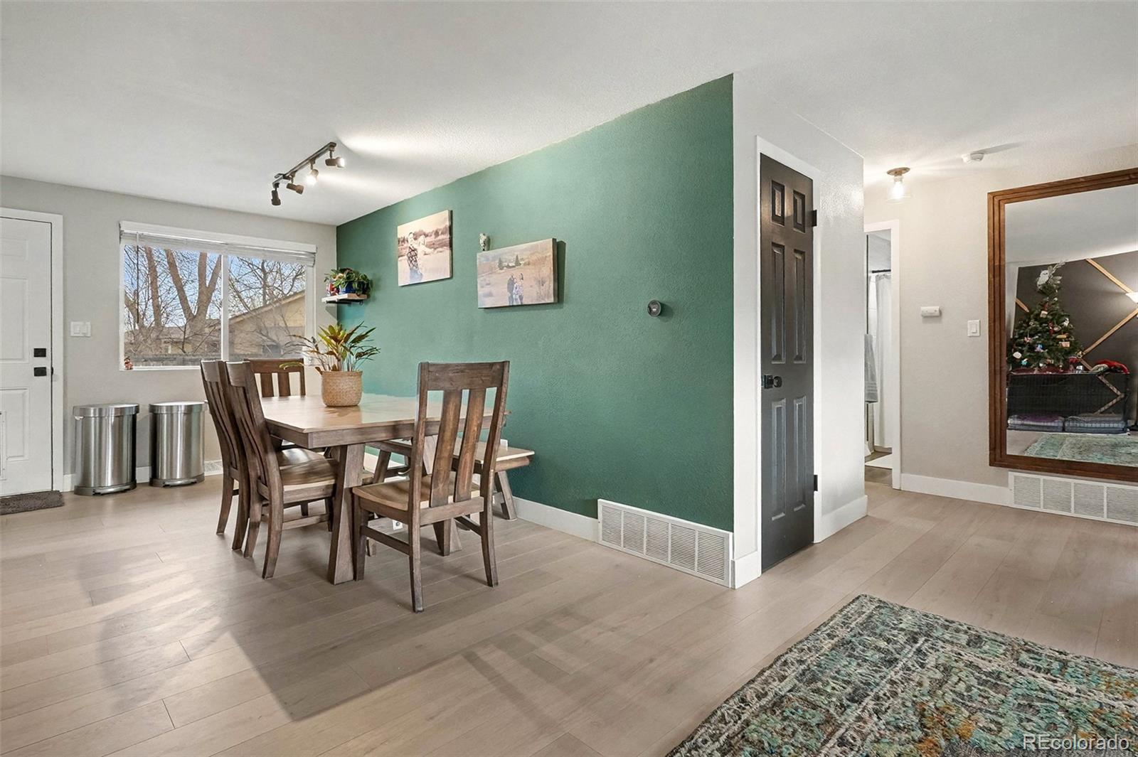 4784 Swadley Street Wheat Ridge, CO 80033 - Photo 6 of 22 a view of a dining room with furniture