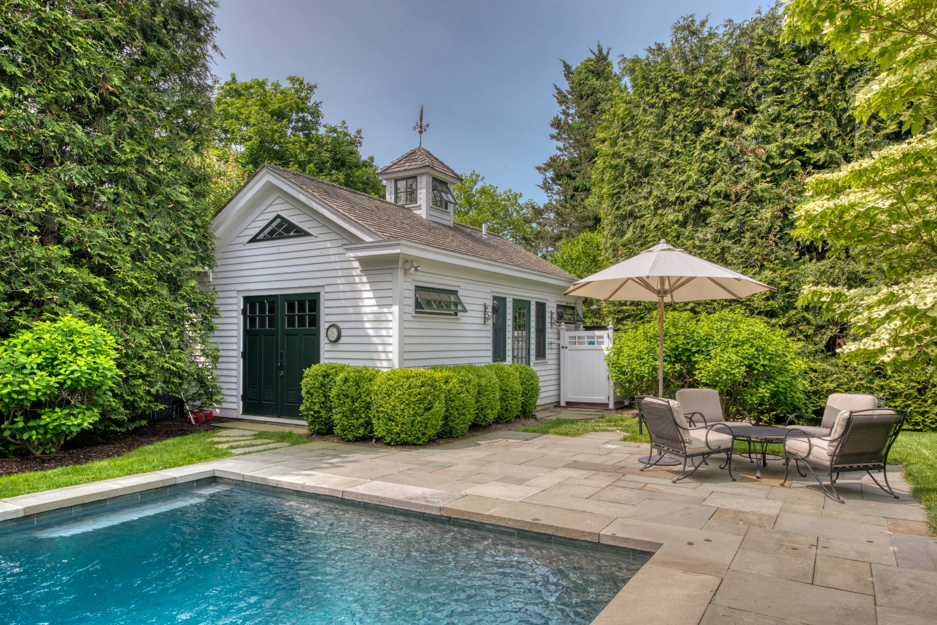 23 Howard Street Sag Harbor, NY 11963 - Photo 2 of 14 a front view of a house with garden