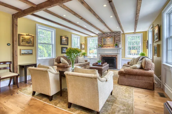 a living room with fireplace furniture and a large window