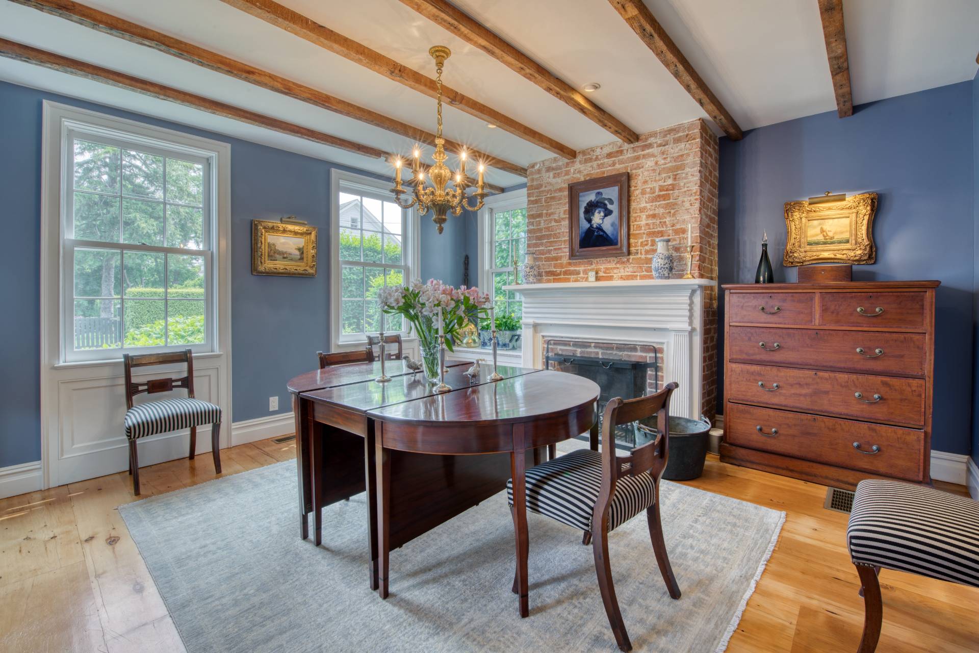 23 Howard Street Sag Harbor, NY 11963 - Photo 5 of 14 a view of a dining room with furniture and chandelier