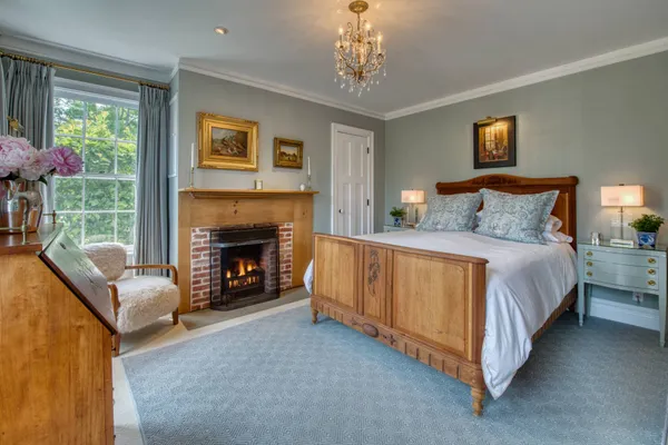 a spacious bedroom with a bed and a fireplace