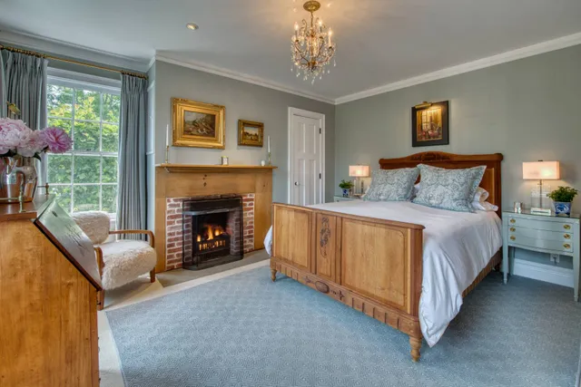 a spacious bedroom with a bed and a fireplace