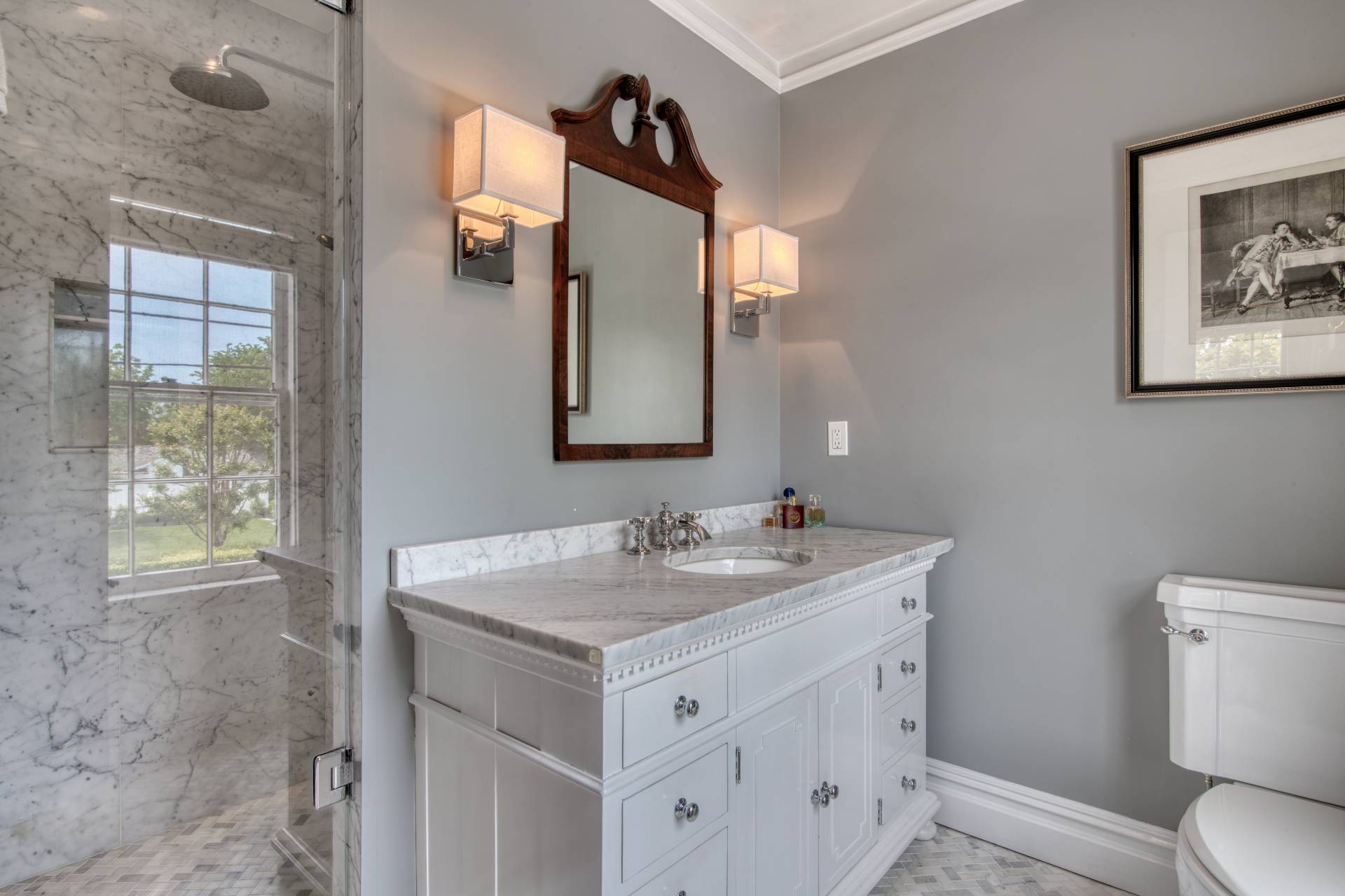 23 Howard Street Sag Harbor, NY 11963 - Photo 10 of 14 a bathroom with a toilet sink and mirror