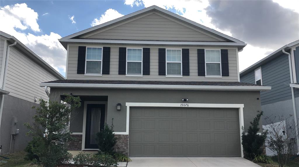 19076 Heavenside Ct Spring Hill Spring Hill, FL 34610 - Photo 1 of 4 a front view of house with yard