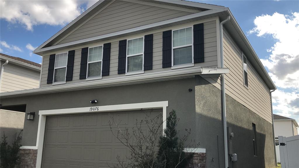 19076 Heavenside Ct Spring Hill Spring Hill, FL 34610 - Photo 2 of 4 a front view of a house with a blue roof