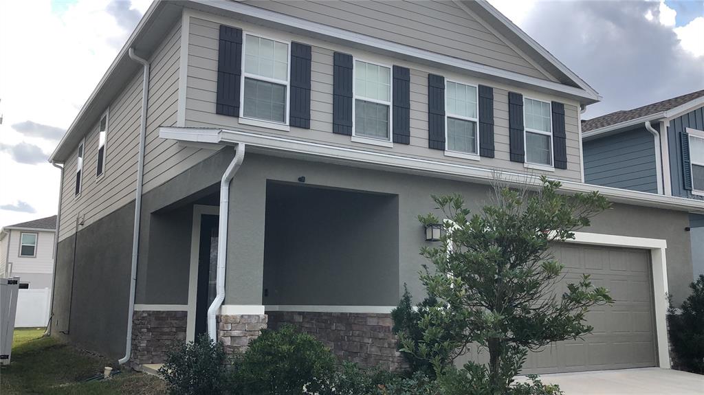 19076 Heavenside Ct Spring Hill Spring Hill, FL 34610 - Photo 3 of 4 a building with potted plants in front of it