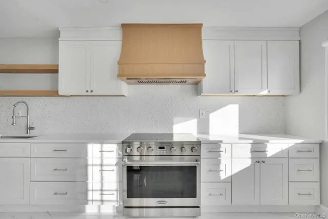 a kitchen with granite countertop white cabinets and white appliances