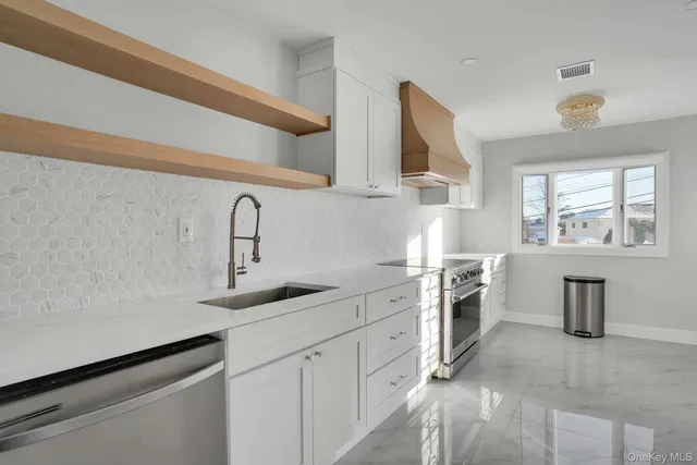a kitchen with a sink cabinets and window