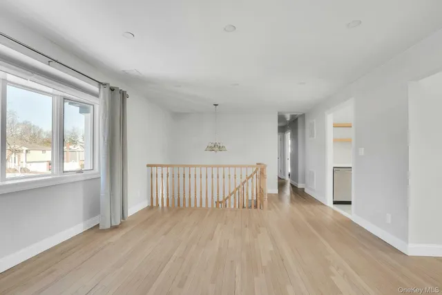 a view of a room with wooden floor and windows