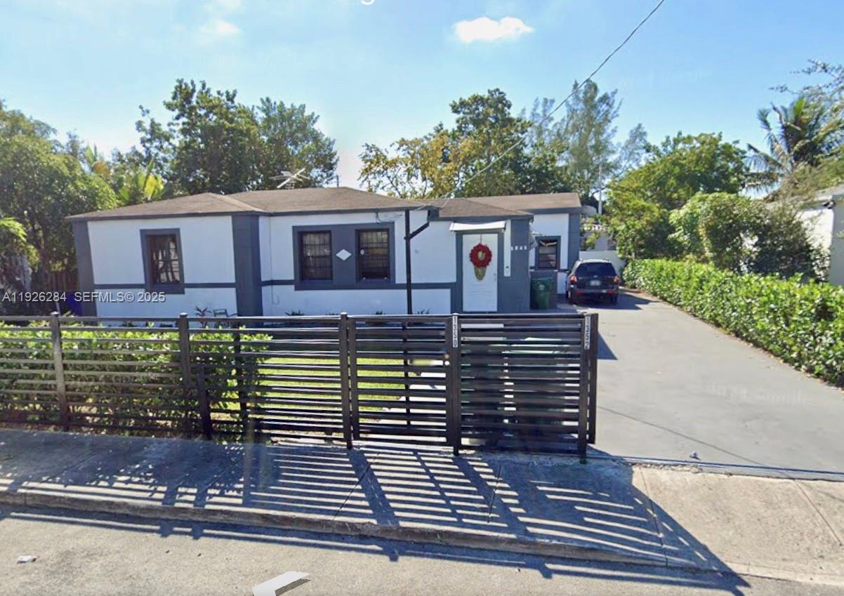 1352 Northwest 52nd Street, Unit B Miami, FL 33142 - Photo 1 of 9 a view of a house with brick walls