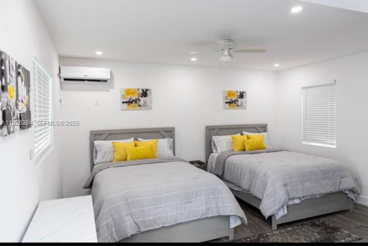 1352 Northwest 52nd Street, Unit B Miami, FL 33142 - Photo 4 of 9 a bedroom with two beds and painting on the wall