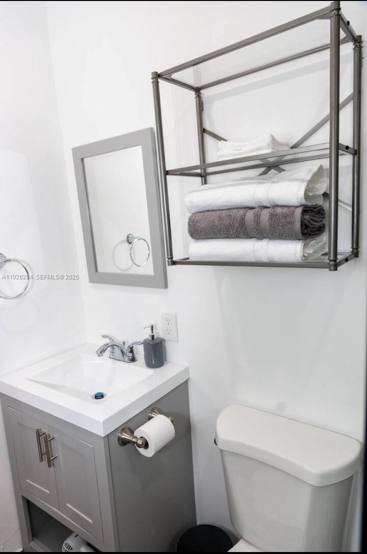 1352 Northwest 52nd Street, Unit B Miami, FL 33142 - Photo 7 of 9 a bathroom with a sink and a mirror
