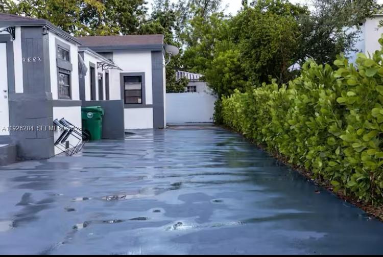 1352 Northwest 52nd Street, Unit B Miami, FL 33142 - Photo 8 of 9 a view of a house with a yard