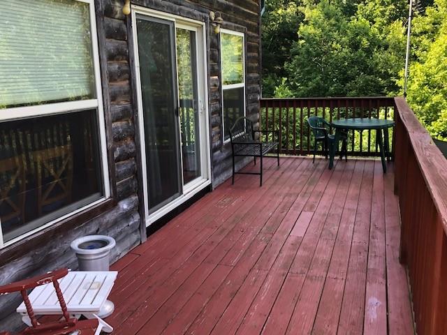 696 Blue Rock Road Purlear, NC 28665 - Photo 3 of 34 a view of balcony with wooden floor and outdoor seating
