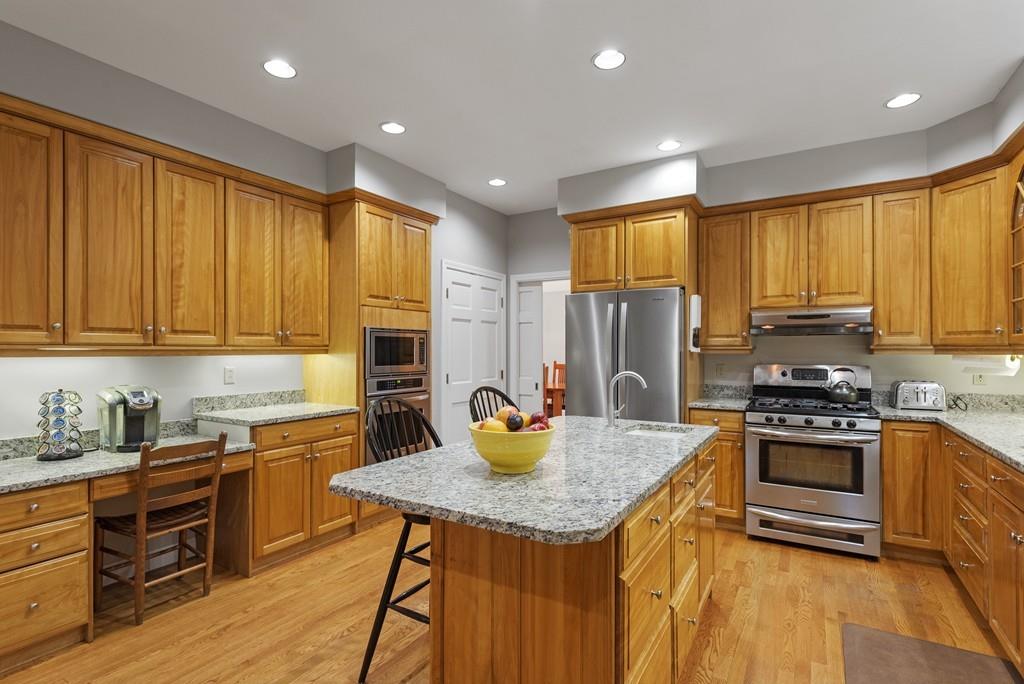 28 Dana Road Boxford, MA 01921 - Photo 8 of 42 a kitchen with kitchen island granite countertop wooden cabinets a stove top oven a sink and dishwasher