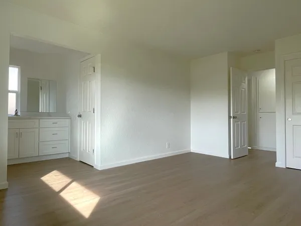 a view of a hallway and closet with cabinet