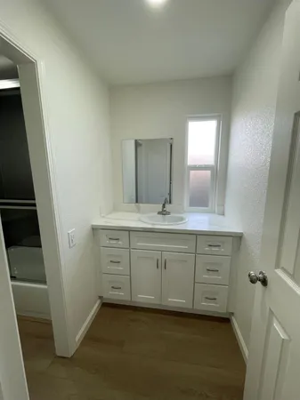 a bathroom with a tub a toilet and a sink