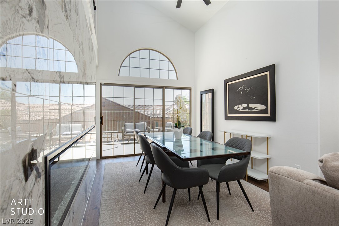 387 Silver Road Mesquite, NV 89027 - Photo 7 of 46 High vaulted ceilings and a classic arched window elevate this formal dining space.