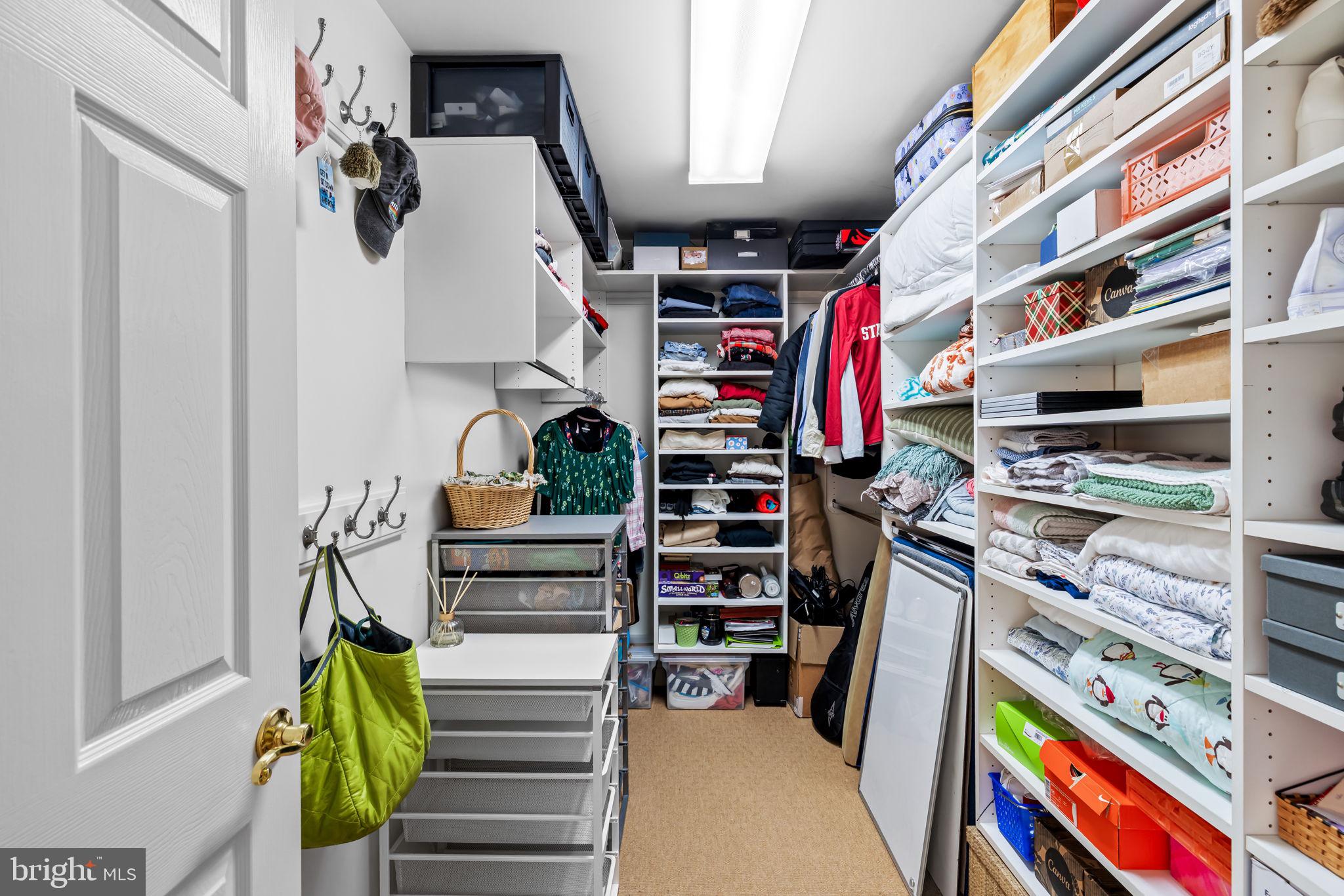 2331 Boston Street, Unit 1 Baltimore, MD 21224 - Photo 47 of 74 a view of walk in closet with clothes and shoes