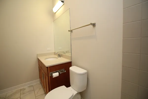 a white toilet sitting next to a bath tub
